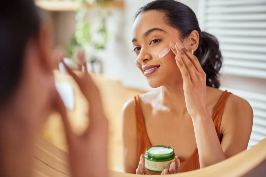 attractive-woman-applying-cream-to-her-face-2026-03-16-05-08-49-utc
